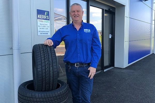 Norman Kerr, owner of Kerr's Tyres, standing outside his business's premises