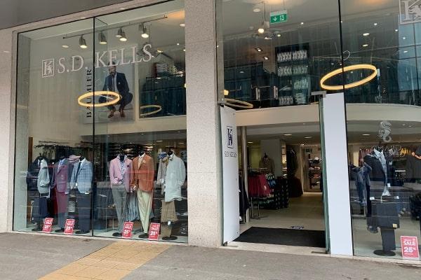 The front exterior of one of SD Kells' department stores, with its glass frontage and mannequin displays