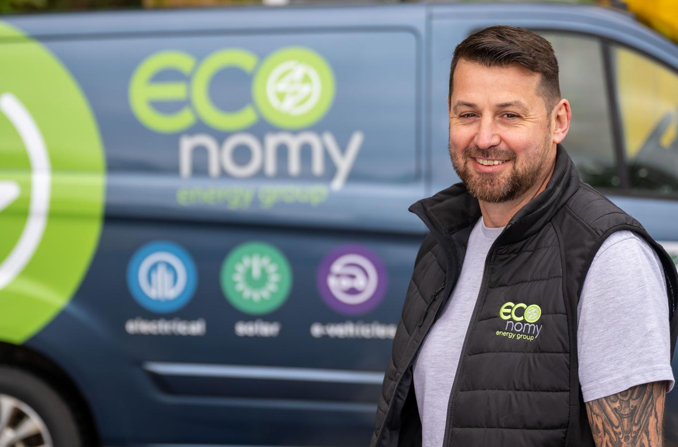 Photo of Economy Energy Group Director Anthony Dixey standing in front of one of his new vans