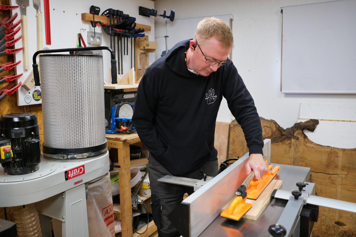 man doing wood working with machinery