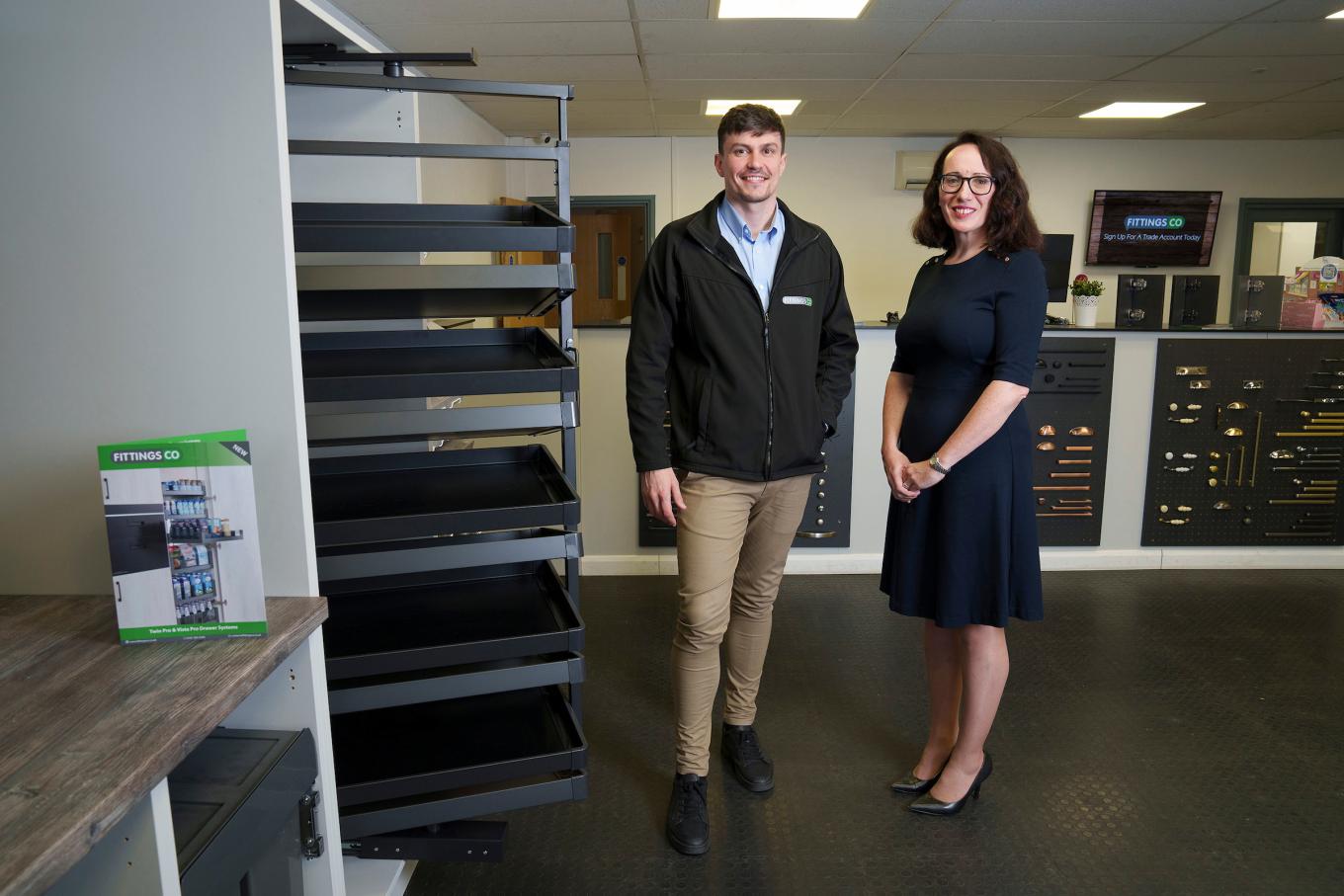 man and woman standing in a fittings showroom