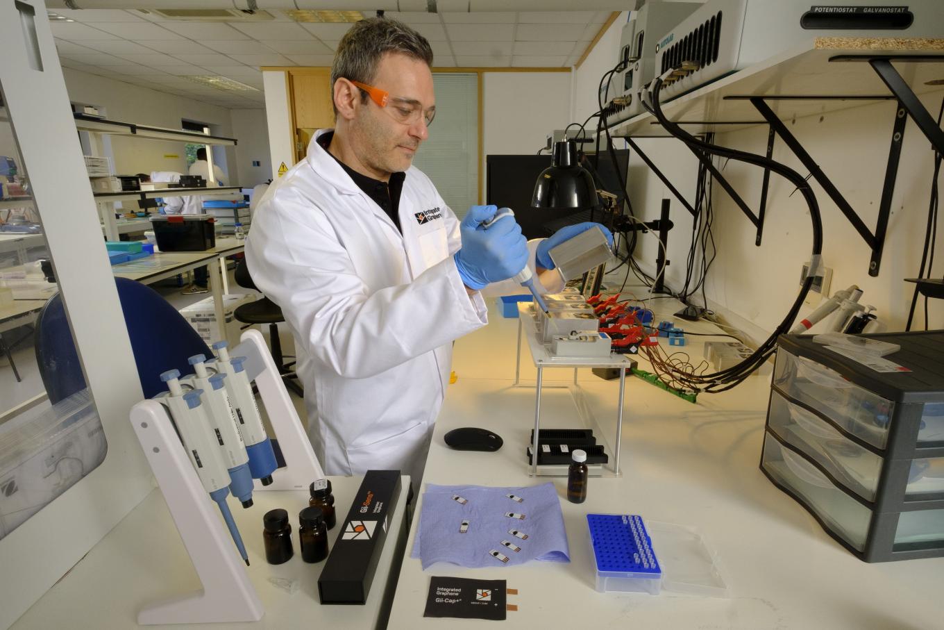 Image of a male wearing a white lab coat in a laboratory based environment