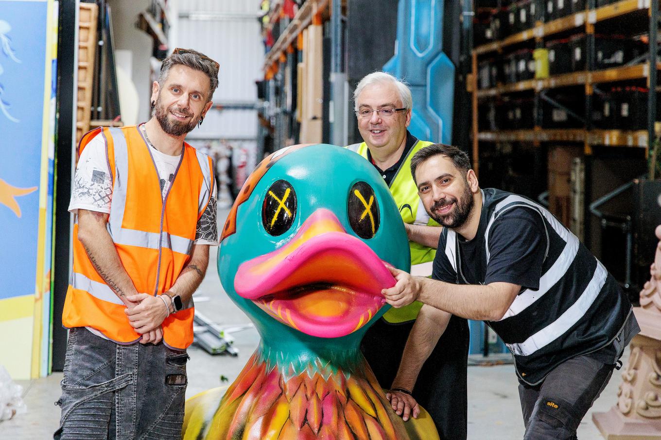 Visual Architect owners stood by one of their products, a blue painted decorative duck.