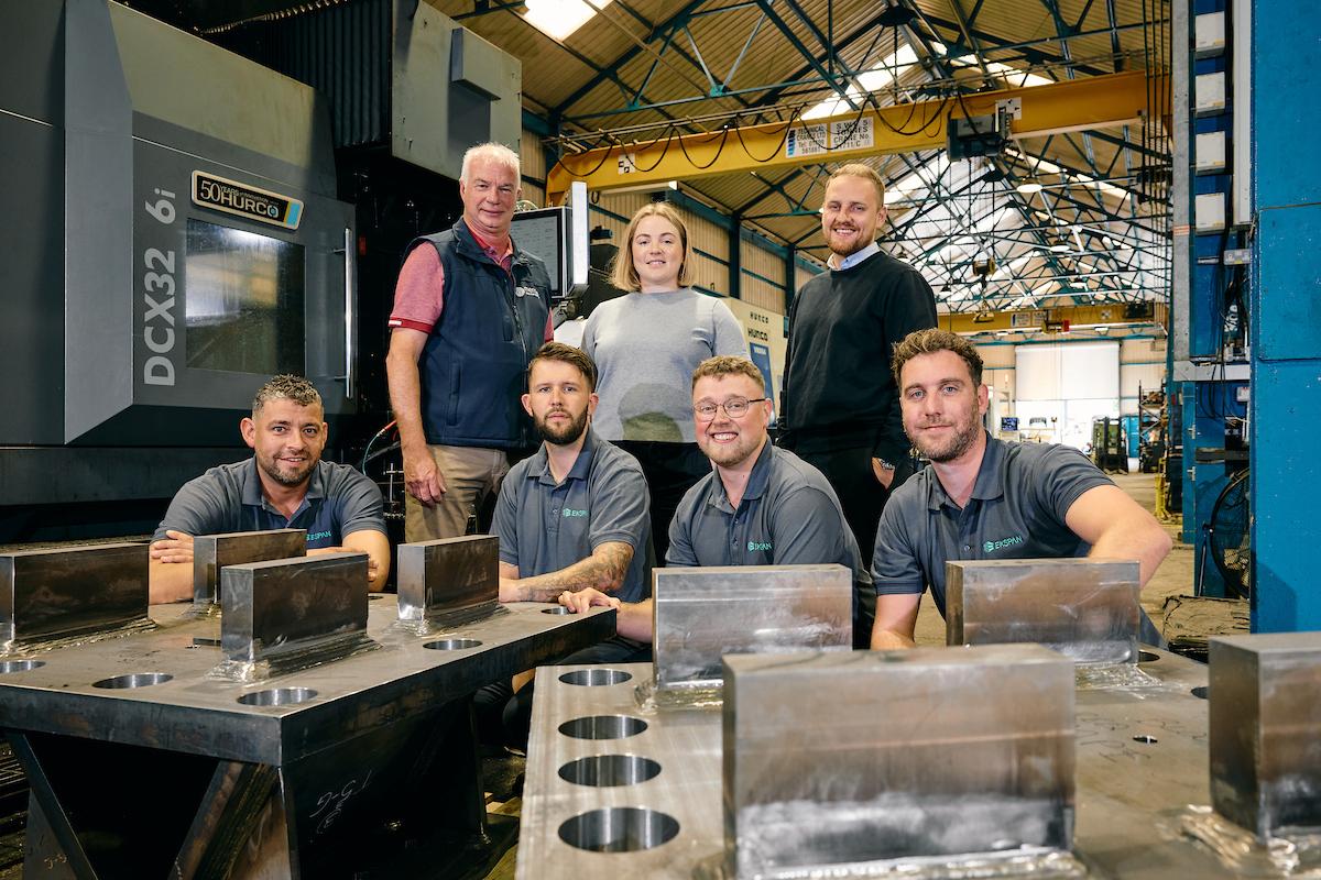 EKSPAN employees sat in a warehouse space