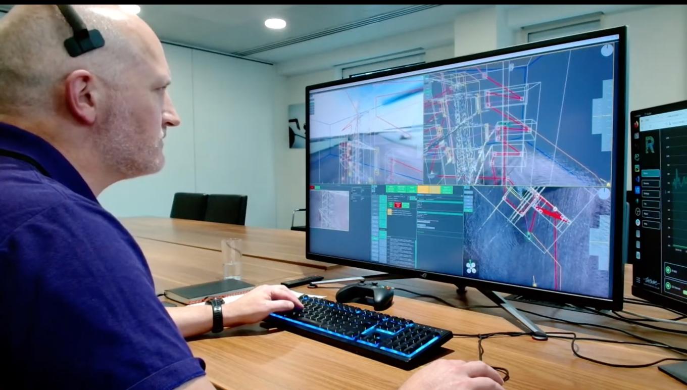 A male employee from sees-ai working at a computer, schematics shown on screen