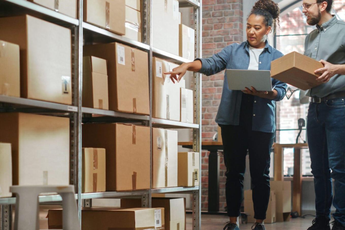 Male and female colleague in a parcel storage space